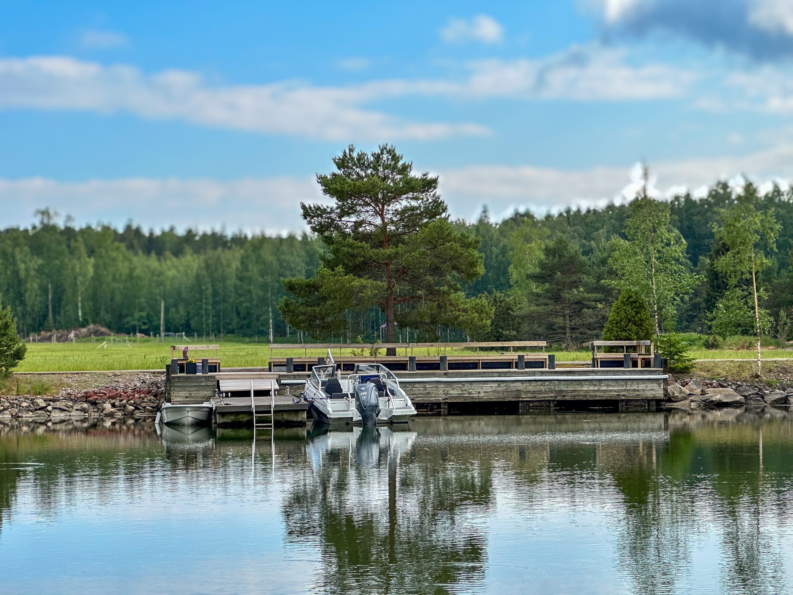 Private dock with motorboats in a sheltered coastal bay in the Finnish Archipelago