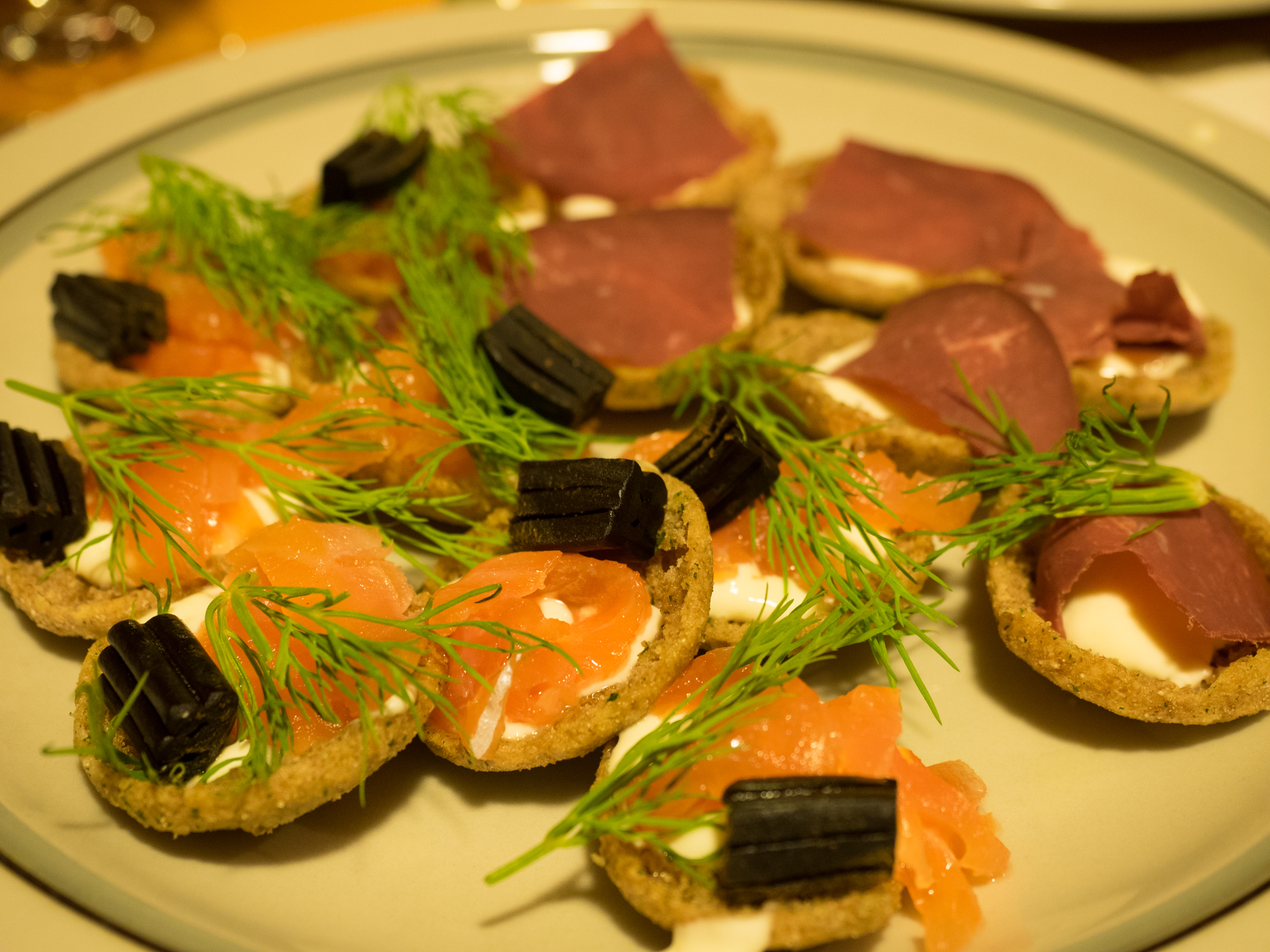 Seasonal Finnish salmon appetisers with fresh dill at a private seaside dinner