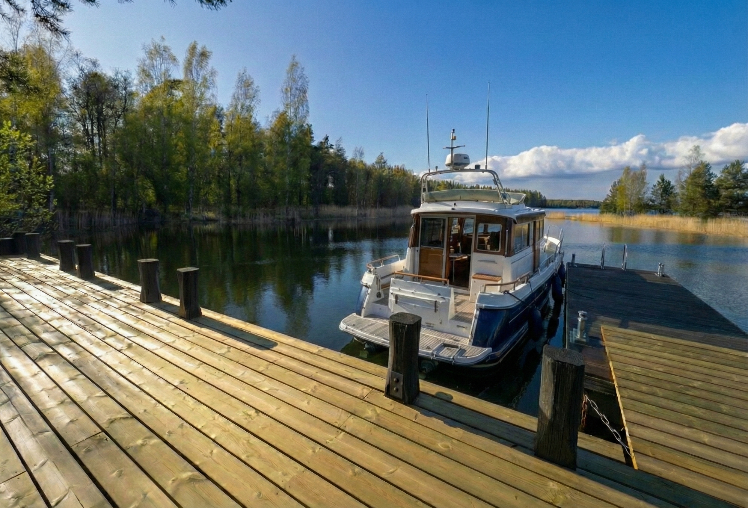 Private yacht moored at a secluded coastal estate dock in the Finnish Archipelago.